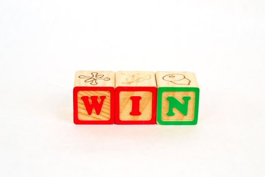 Vintage alphabet blocks spelling out WIN