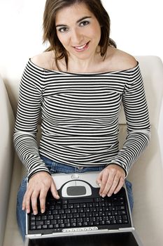 Beautiful and happy young woman working with a laptop