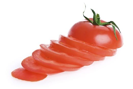 A whole sliced tomato, isolated on white.