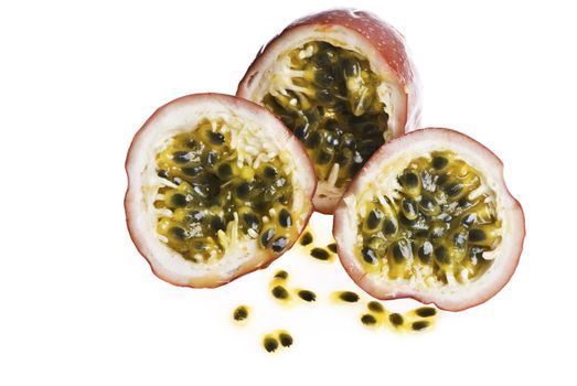 Passionfruit cut into peices, with seeds. Isolated on white.