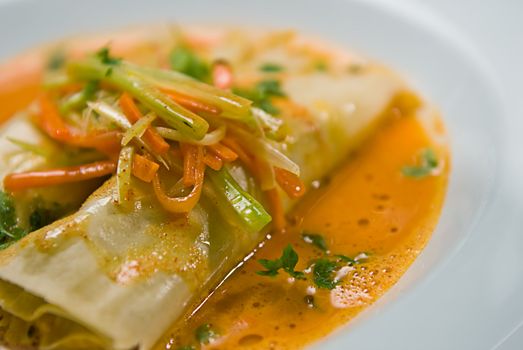A soup and pasta dish. served with vegetables.