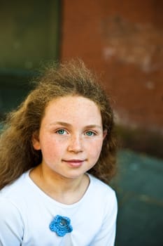 young girl with freckles looking into camera