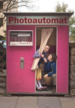 boy and girl being silly at photo booth