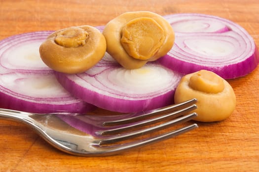 mushrooms and onions on a cutting board