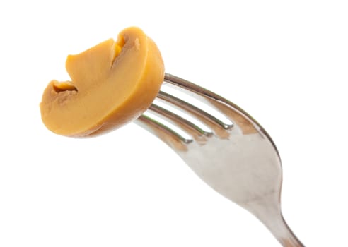 mushroom on a fork isolated on white background