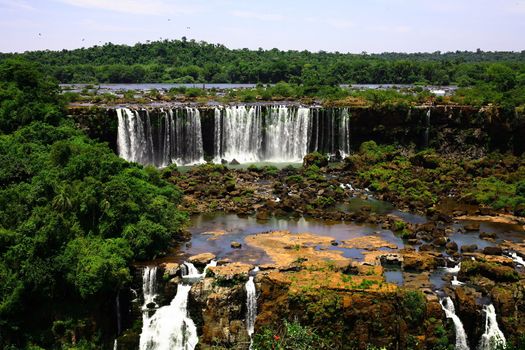 The Iguassu (or Iguazu) Falls is one of the largest masses of fresh water on the planet and divides, in South America, Brazil, Paraguay and Argentina. The waterfall system consists of 275 falls along 2.7 kilometres (1.67 miles) of the Iguazu River. Some of the individual falls are up to 82 metres (269 feet) in height, though the majority are about 64 metres (210 feet).