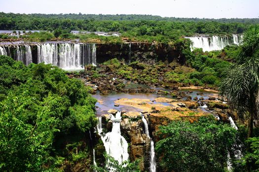 The Iguassu (or Iguazu) Falls is one of the largest masses of fresh water on the planet and divides, in South America, Brazil, Paraguay and Argentina. The waterfall system consists of 275 falls along 2.7 kilometres (1.67 miles) of the Iguazu River. Some of the individual falls are up to 82 metres (269 feet) in height, though the majority are about 64 metres (210 feet).