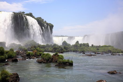 The Iguassu (or Iguazu) Falls is one of the largest masses of fresh water on the planet and divides, in South America, Brazil, Paraguay and Argentina. The waterfall system consists of 275 falls along 2.7 kilometres (1.67 miles) of the Iguazu River. Some of the individual falls are up to 82 metres (269 feet) in height, though the majority are about 64 metres (210 feet).