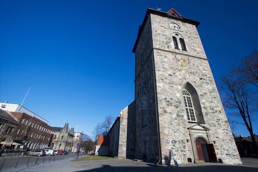 "vår frues" church in the middle of Trondheim, Norway. An old and classic medieval church which stands between modern buildings of the city and the Nidaros Cathedral. 