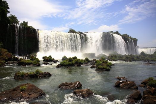 The Iguassu (or Iguazu) Falls is one of the largest masses of fresh water on the planet and divides, in South America, Brazil, Paraguay and Argentina. The waterfall system consists of 275 falls along 2.7 kilometres (1.67 miles) of the Iguazu River. Some of the individual falls are up to 82 metres (269 feet) in height, though the majority are about 64 metres (210 feet).