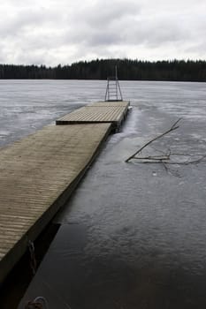 Swimming platform on a lake just before the ice breaks in spring.
