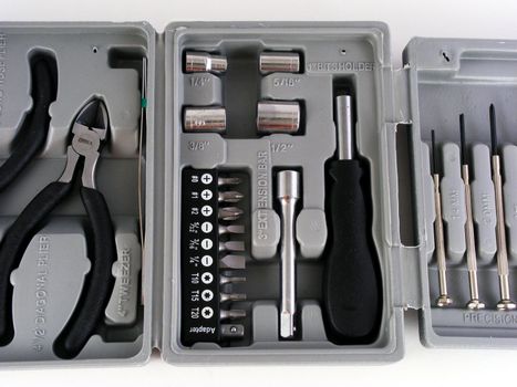 Part of a small toolkit for do it yourself home repairs which includes screwdrivers and pliers.