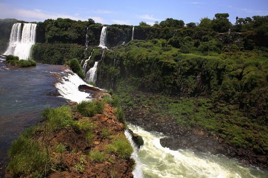 The Iguassu (or Iguazu) Falls is one of the largest masses of fresh water on the planet and divides, in South America, Brazil, Paraguay and Argentina. The waterfall system consists of 275 falls along 2.7 kilometres (1.67 miles) of the Iguazu River. Some of the individual falls are up to 82 metres (269 feet) in height, though the majority are about 64 metres (210 feet).