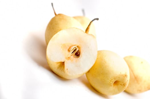 five fruit pears with one sliced into half