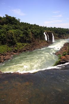 The Iguassu (or Iguazu) Falls is one of the largest masses of fresh water on the planet and divides, in South America, Brazil, Paraguay and Argentina. The waterfall system consists of 275 falls along 2.7 kilometres (1.67 miles) of the Iguazu River. Some of the individual falls are up to 82 metres (269 feet) in height, though the majority are about 64 metres (210 feet).