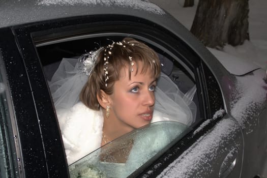 young bride looking from window of car
