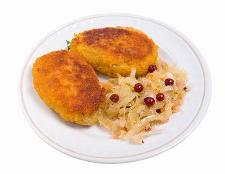Cutlets in a plate with vegetables.pickled cabbage and cowberry