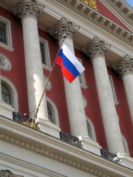 Russian flag with official building (Moscow city Duma) as a background