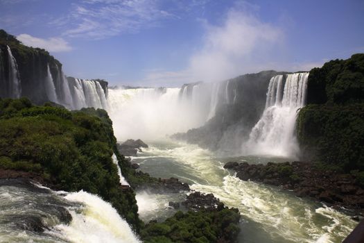 The Iguassu (or Iguazu) Falls is one of the largest masses of fresh water on the planet and divides, in South America, Brazil, Paraguay and Argentina. The waterfall system consists of 275 falls along 2.7 kilometres (1.67 miles) of the Iguazu River. Some of the individual falls are up to 82 metres (269 feet) in height, though the majority are about 64 metres (210 feet).