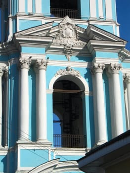 Blue classical building with white columns, part of bell-tower, Moscow, Russia