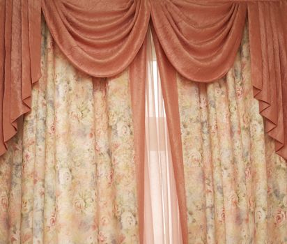Two pink portieres at a window