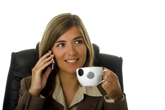 Young and beautiful business woman drinking a coffee in the office