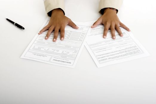 Woman hands over the table with contract to sign