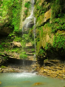 Small waterfall and stone