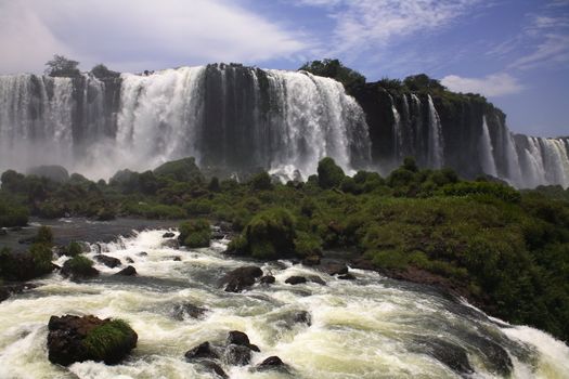 The Iguassu (or Iguazu) Falls is one of the largest masses of fresh water on the planet and divides, in South America, Brazil, Paraguay and Argentina. The waterfall system consists of 275 falls along 2.7 kilometres (1.67 miles) of the Iguazu River. Some of the individual falls are up to 82 metres (269 feet) in height, though the majority are about 64 metres (210 feet).