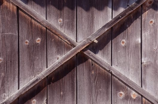 Fragment of old building wall made of wooden planks.