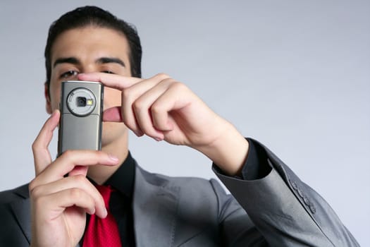 Businessman with gray suit taking photos with phone camera