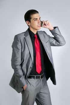 Businessman with gray suit talking cellular phone with suit and red tie