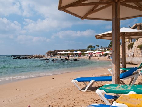 Summer vacation beach resort with umbrellas and colorful chairs