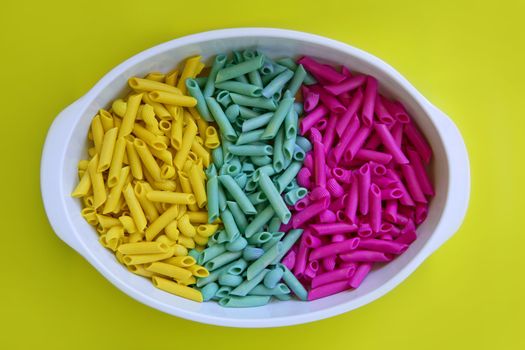 Colorful pasta food in three colors, yellow, blue and pink