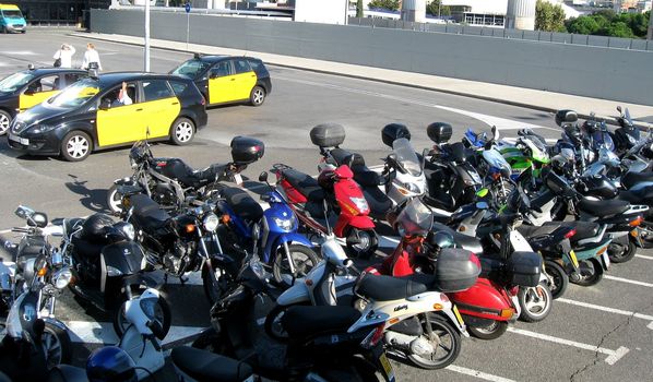 Line of scooters parked along road side