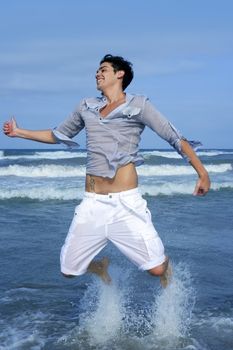 Handsome young man on the blue ocean beach summer sea