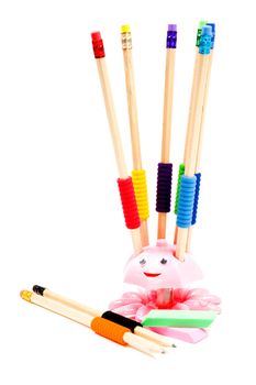 An isolated pencil holder with colorful pencils on white