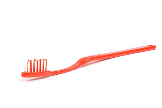red toothbrush isolated on a white background