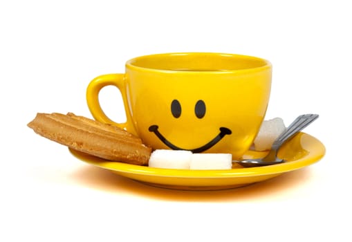 Happy yellow cup of tea with a cookie