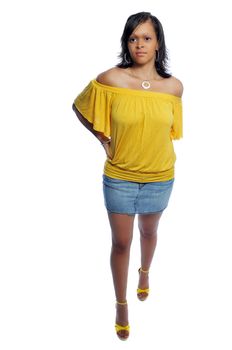 Attractive young woman in a yellow top and short skirt