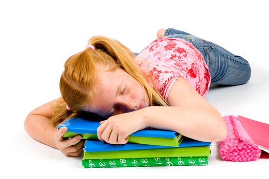 Child sleeping while working on homework on white background
