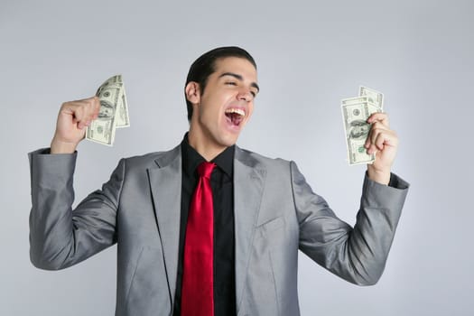 Businessman young with dollar notes suit and tie on gray background