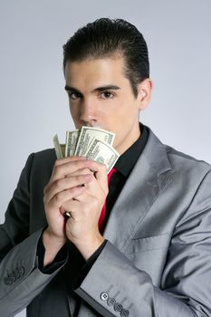 Businessman young with dollar notes suit and tie on gray background