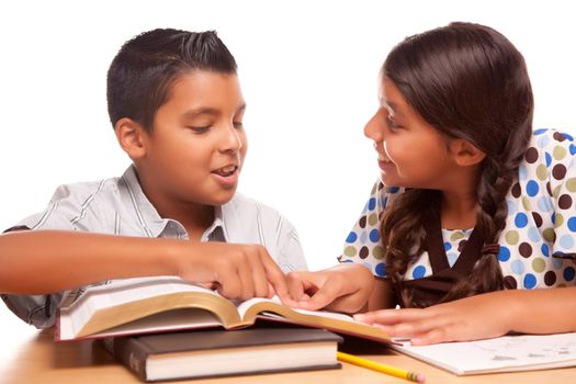 Hispanic Brother and Sister Having Fun Studying Together Isolated on a White Background.