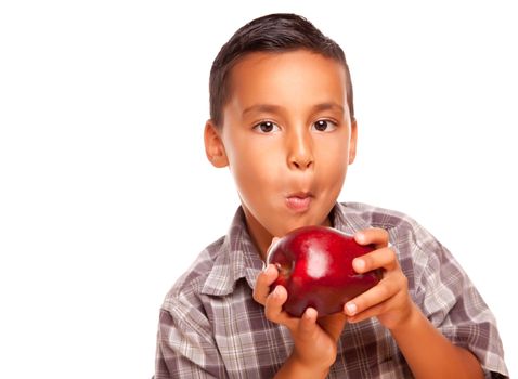 Adorable Hispanic Boy Eating a Large Red Apple Isolated on a White Background.