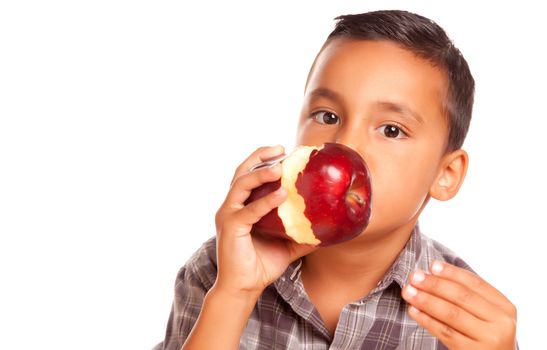 Adorable Hispanic Boy Eating a Large Red Apple Isolated on a White Background.