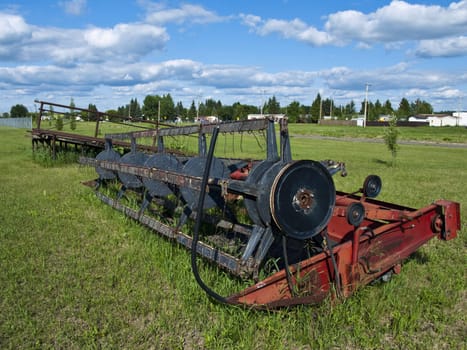 Antique farm machinery abandoned in a field.