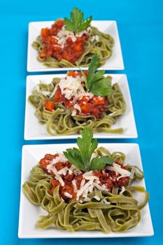 tagliatelle with sauce bolognaise in white plates