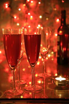 Champagne on red background with blured lights.