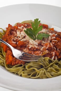 tagliatelle with sauce bolognaise in white plates